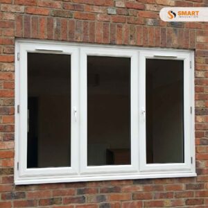 White uPVC 3 pane combination casement window with side opening panels installed in brick wall