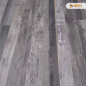 Geneva Oak Grey rigid flooring planks laid out beautifully across a spacious, sunlit minimalist dining hall