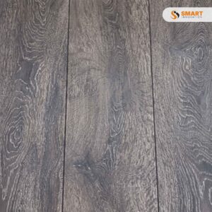 Laminate Bedrock Oak 8mm earth-toned planks fitted continuously across a modern open-plan dining and living environment